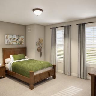 A cozy bedroom with a wooden bed and green bedding, complemented by neutral walls and natural light.