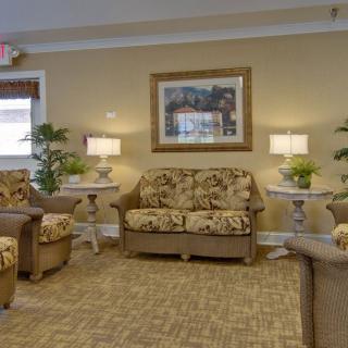 A cozy living room with floral-patterned furniture and ambient lighting.