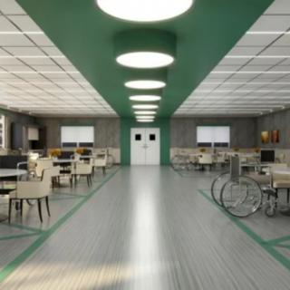 A modern library interior with desks and chairs arranged in neat rows, illuminated by circular ceiling lights.