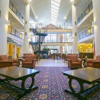 A spacious and modern lobby with comfortable seating, skylights, and a stylish design.