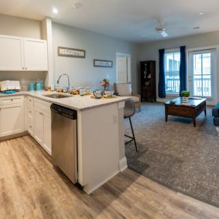 Open floor plan with a modern kitchen and cozy living room area.
