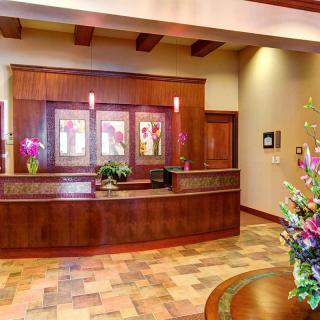 A welcoming reception area with a wooden counter and floral decor.