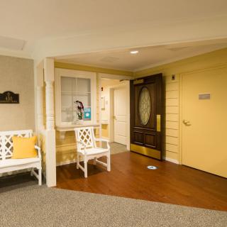 A cozy hotel lobby with seating and an entrance door.