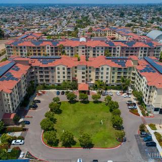 An aerial view of a large residential complex with a central courtyard surrounded by buildings.