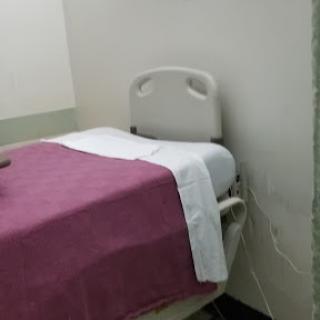 A hospital bed prepared for a patient in a medical facility.