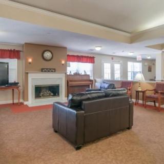 A spacious living room with a fireplace, TV, and comfortable seating.