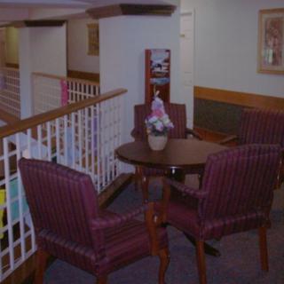 A cozy indoor seating area with a round table and chairs.