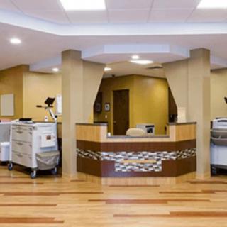 A modern hospital reception area with a central desk and medical equipment.