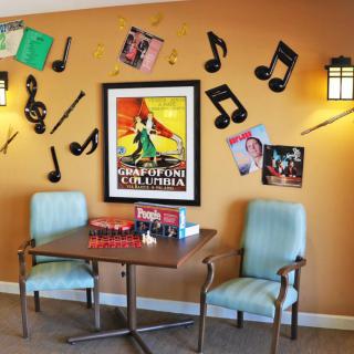 A cozy corner with a music-themed decor featuring vintage posters and musical notes on the wall.