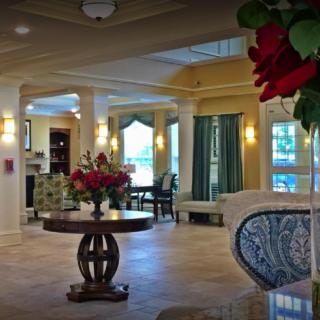 A beautifully decorated lobby with elegant furniture and floral arrangements.