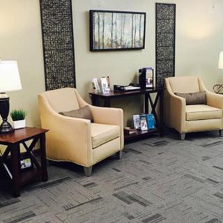 A cozy waiting room with comfortable chairs and elegant decor.