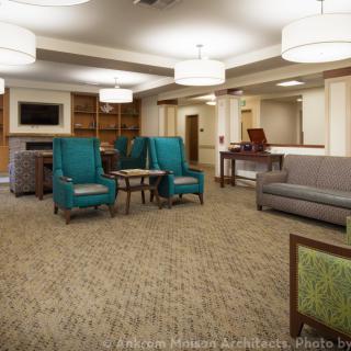 A cozy living room with comfortable seating and warm lighting.
