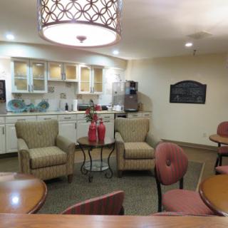 A cozy lounge area featuring comfortable chairs and a kitchenette.