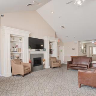 A cozy living room with a fireplace, television, and comfortable seating.