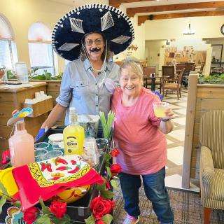 Two people celebrating indoors with festive decorations and food.