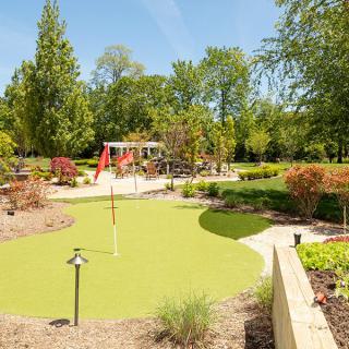 A beautifully landscaped garden featuring lush greenery and a winding pathway.