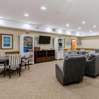 A comfortable, well-lit living room with seating and a TV.