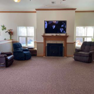 A cozy living room with a fireplace, television, and comfortable seating.