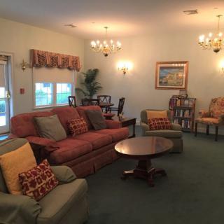 A cozy living room with traditional furnishings and warm lighting.