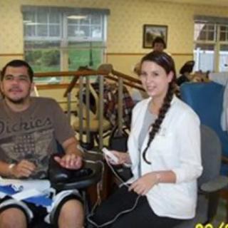 A therapist assists a patient during a rehabilitation session.