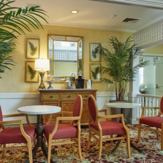 A cozy lobby area with seating, plants, and decorative elements.
