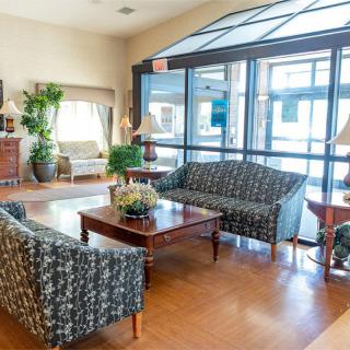 A bright and welcoming lobby area with comfortable seating and indoor plants.