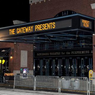 The Gateway theater entrance lit up at night.