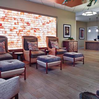 A cozy and inviting reception area with comfortable seating and warm lighting.