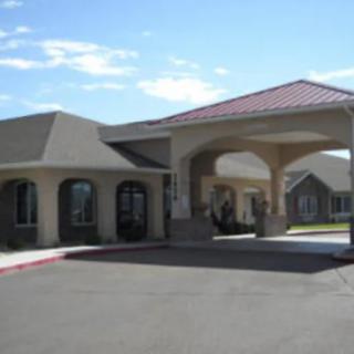 A commercial building with a covered entrance and clear sky in the background.