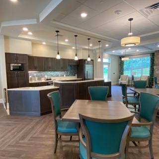 A modern kitchen and dining area with stylish lighting and furniture.
