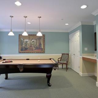 A modern game room with a pool table and elegant decor.