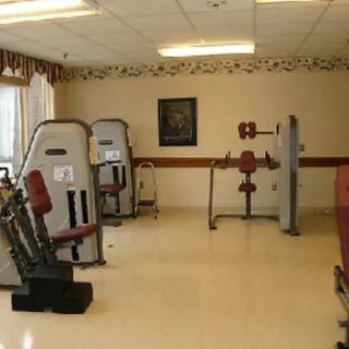 A gym with various exercise machines and fitness equipment.