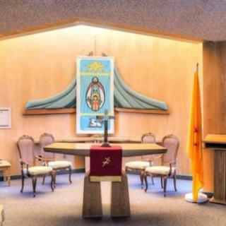 A chapel interior featuring an altar with a depiction of Our Lady of Guadalupe.