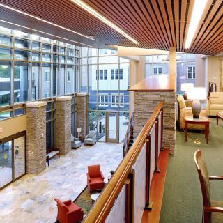 A modern lobby interior with comfortable seating and large windows.