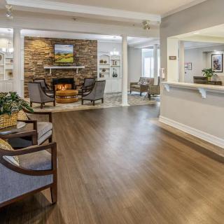 A spacious and inviting lobby area featuring comfortable seating and a fireplace.