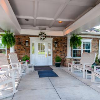 A welcoming entrance with seating area and decorative plants.