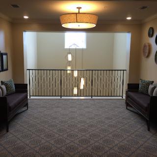 A modern interior space featuring a cozy lounge area with seating and stylish lighting.