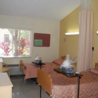A hospital room with twin beds and medical equipment.