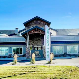 A modern commercial building featuring a welcoming entrance and attractive landscaping.