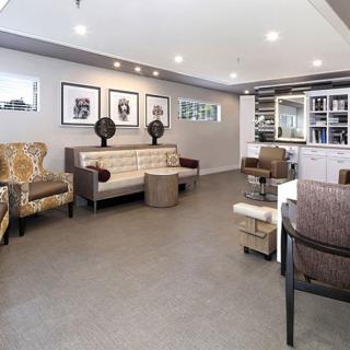 A modern lounge area featuring stylish seating and contemporary artwork.