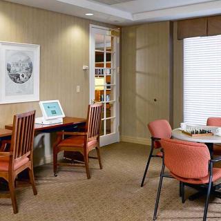 A cozy office space with a computer station and a small meeting table.