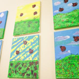 A vibrant display of abstract landscape paintings, showcasing a variety of colors and textures.