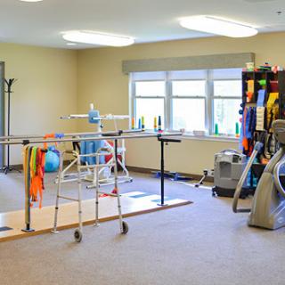 A well-equipped rehabilitation therapy room featuring various exercise equipment.