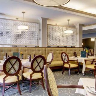 A cozy and elegantly designed restaurant dining area with neatly arranged tables and chairs.