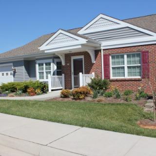 A single-story suburban house with a well-maintained lawn and driveway.