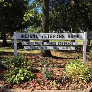 A sign marking the Indiana Veterans Home, dedicated to providing care and support for veterans.