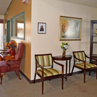 A cozy waiting room with chairs and a decorative setup.