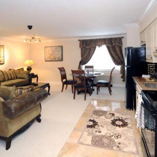 An open-plan living space with a cozy sofa, dining table, and a kitchen area.