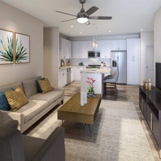 A modern open-concept living room and kitchen space with a comfortable seating area, contemporary decor, and a stylish kitchen island.
