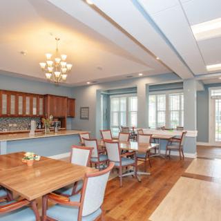 A modern kitchen and dining area featuring wooden furniture and ample natural light.